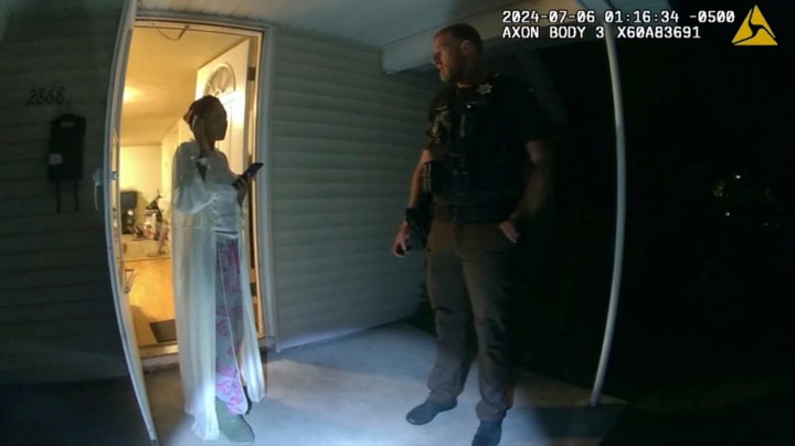 In this image taken from body-camera video released by Illinois State Police, Sonya Massey, left, talks with Sean Grayson outside her home in Springfield, Illinois, on July 6, 2024. Footage released Monday, July 22, reveals a chaotic scene in which Grayson shoots Massey in the face in her own home after she called 911 for help.