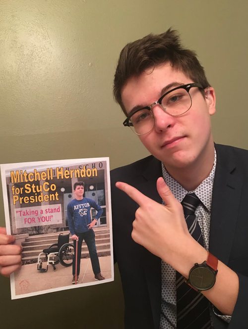 Mitchell with his poster for his high school student council presidential campaign in 2017. “He was elected student council president,” the author writes. “This is exactly who Mitchell was. He tried to use humor to disarm others in relation to his disabilities.”