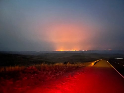 In this image provided by the Oregon Department of Transportation, the Durkee fire burns in the background as it nears Interstate 84 near Huntington, Ore., on July 21, 2024.