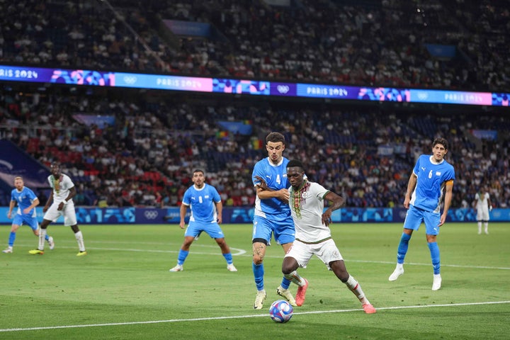 Stav Lemkin of Team Israel battles for the ball with Cheickna Doumbia of Mali.