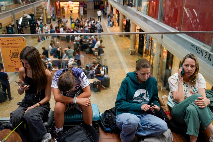 Travelers wait inside the Gare de Bordeaux Saint-Jean at the 2024 Summer Olympics, Friday, July 26, 2024, in Bordeaux, France. (AP Photo/Moises Castillo)