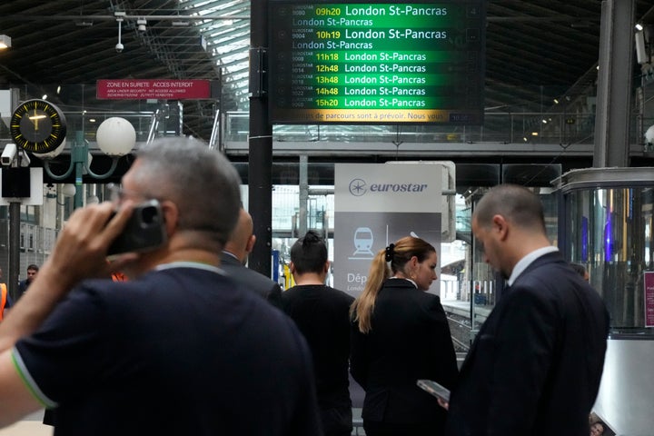 Travelers wait at the Eurostar platform inside the Gare du Nord train station at the 2024 Summer Olympics, Friday, July 26, 2024, in Paris, France. Hours away from the grand opening ceremony of the Olympics, high-speed rail traffic to the French capital was severely disrupted on Friday by what officials described as 