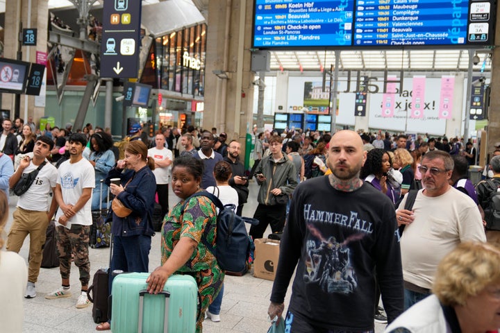 Travelers wait inside the Gare du Nord train station at the 2024 Summer Olympics, Friday, July 26, 2024, in Paris, France. (AP Photo/Mark Baker)