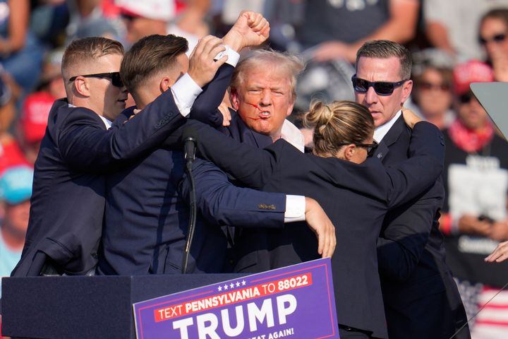 FILE - Republican presidential candidate and former president, Donald Trump, is helped off stage after an assassination attempt at a campaign event in Butler, Pennsylvania, Saturday, July 13, 2024. (AP Photo/Gene J. Puskar, File)