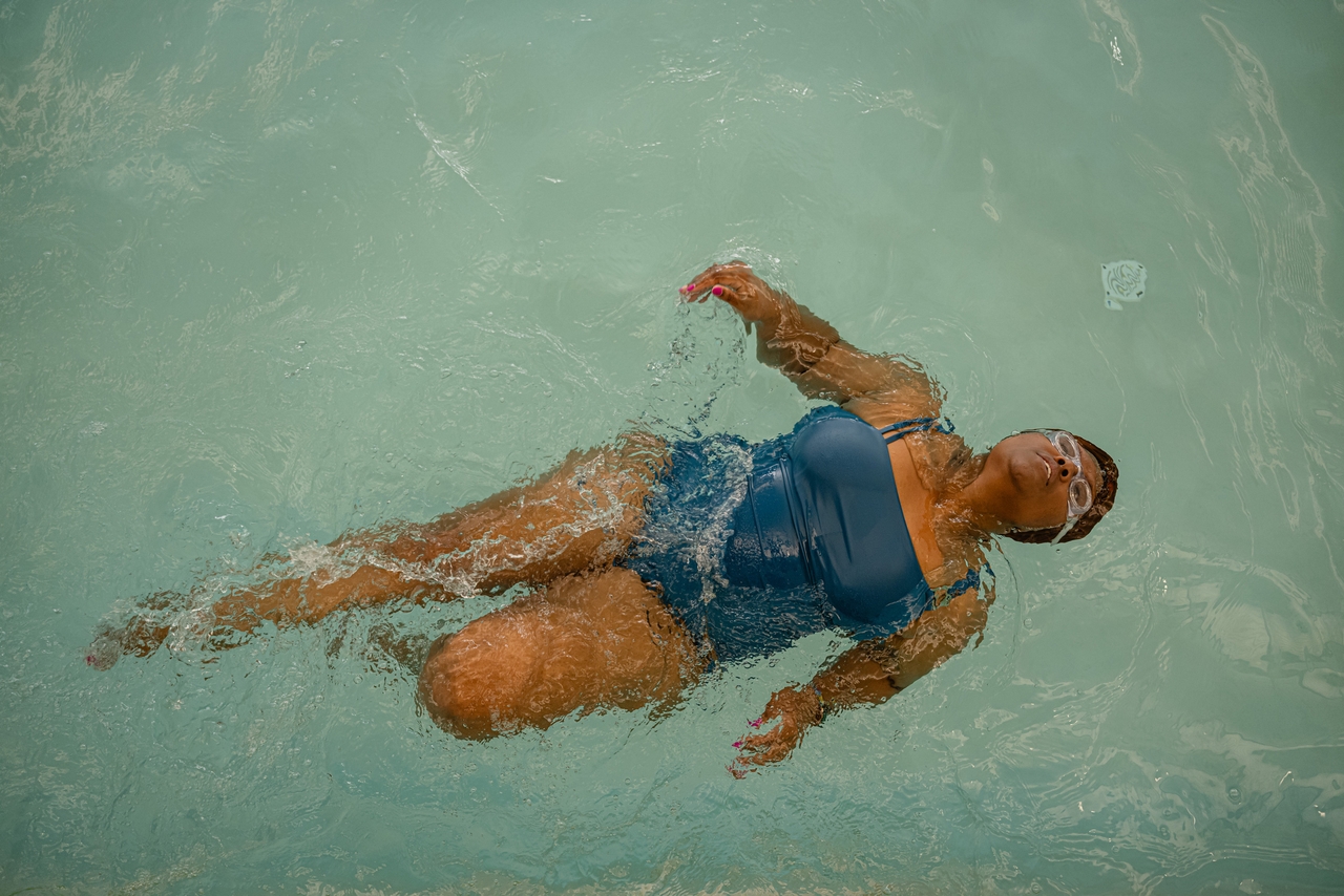 Clark berenang gaya punggung di kolam renang di Republic Bank Foundation YMCA.