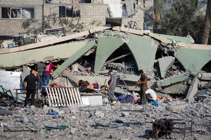 Palestinians inspect the rubble of a school destroyed in an Israeli airstrike on Deir al-Balah, central Gaza Strip, Saturday, July 27, 2024.