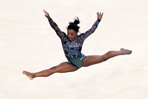 Simone Biles competes in the floor exercise after earlier appearing to hurt her lower leg as she landed from a tumbling sequence.