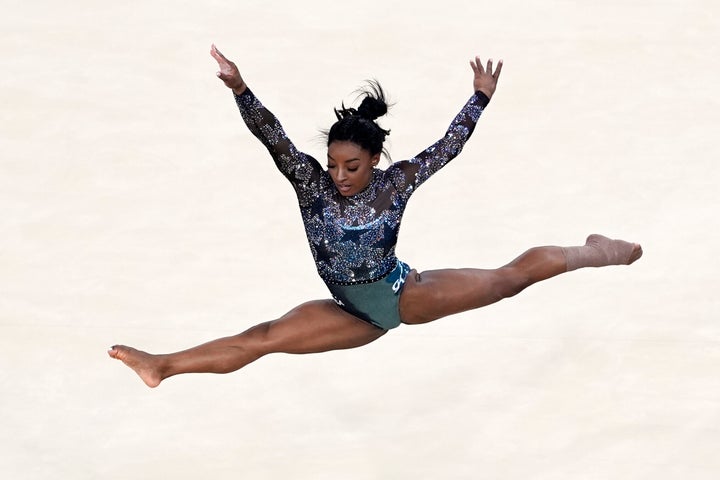 Biles competes in the floor exercise after appearing to hurt her lower leg as she landed from a tumbling sequence during practice.