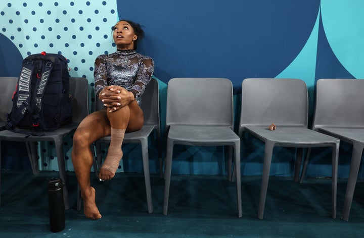 Simone Biles turned pensive after her leg got wrapped.