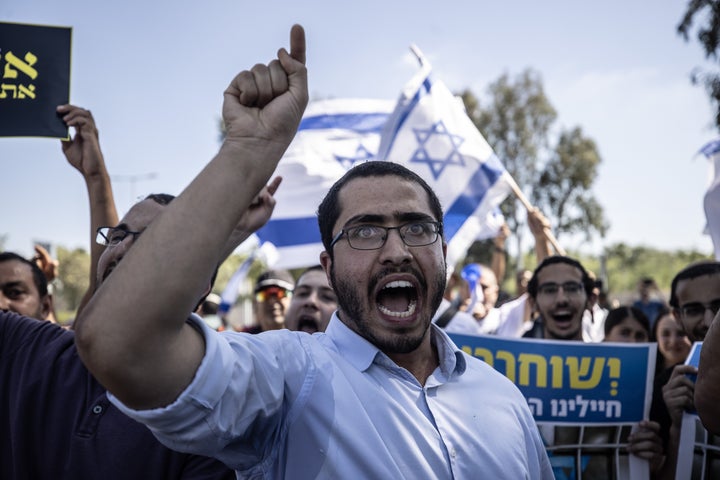 Far-right Israelis and relatives of the defendants gather outside the military court building in Netanya, Israel, on July 30, 2024, to protest the arrest of nine soldiers accused of sexually abusing a Palestinian in the seedy Sde Teiman prison in the Negev desert.