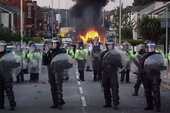 Riot police hold back protesters after disorder broke out on July 30, 2024 in Southport, England. 