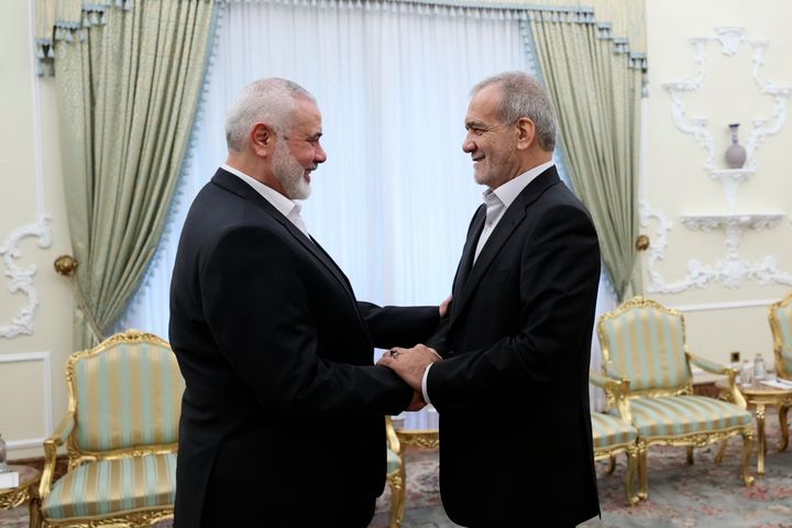 President Masoud Pezeshkian, right, shakes hands with Hamas chief Ismail Haniyeh, in Tehran, shortly before Haniyeh's death.