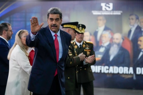 Venezuelan President Nicolas Maduro waves after speaking to the press at the Supreme Court in Caracas, Venezuela, on Wednesday.