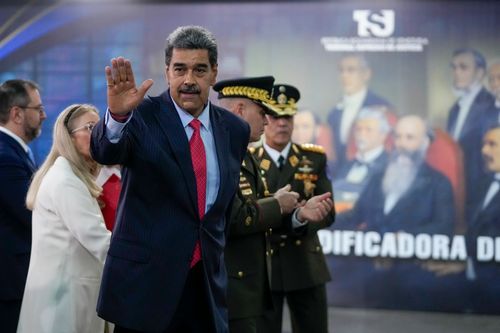 Venezuelan President Nicolas Maduro waves after speaking to the press at the Supreme Court in Caracas, Venezuela, on Wednesday.