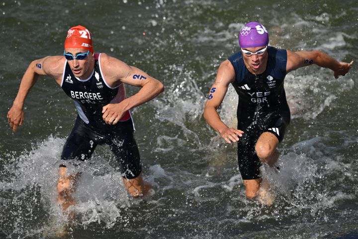 France's Leo Bergere (left) and Great Britain's Alex Yee (right) escape from the Seine. Triathletes braved the murky river on Wednesday after poor water quality prompted minor delays to the competition.