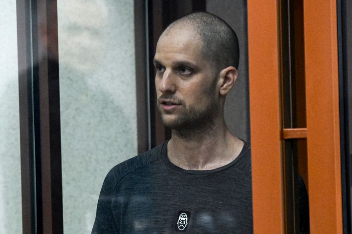 Wall Street Journal reporter Evan Gershkovich stands listening to the verdict in a glass cage of a courtroom inside the building of "Palace of justice," in Yekaterinburg, Russia, on Friday, July 19, 2024. 