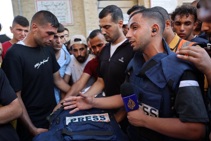 Mourners and colleagues surround the body of Al Jazeera Arabic journalist Ismail al-Ghoul, killed along with his cameraman Rami al-Rifi in an Israeli strike during their coverage of Gaza's Al-Shati refugee camp on Wednesday.