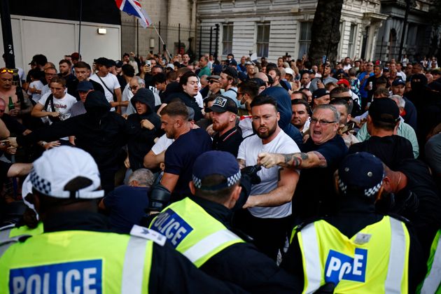 Protestors remonstrate with Police during the 'Enough is Enough' demonstration on Whitehall, outside the entrance to 10 Downing Street in central London on July 31, 2024.