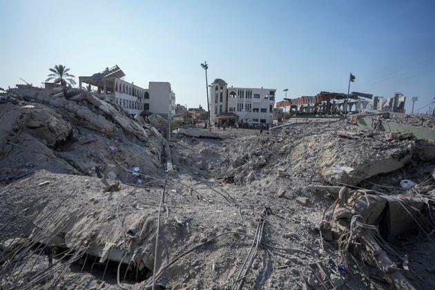 Palestinians inspect the rubble of a school destroyed in an Israeli airstrike on Deir al-Balah, central Gaza Strip, Saturday, July 27, 2024. (AP Photo/Abdel Kareem Hana)