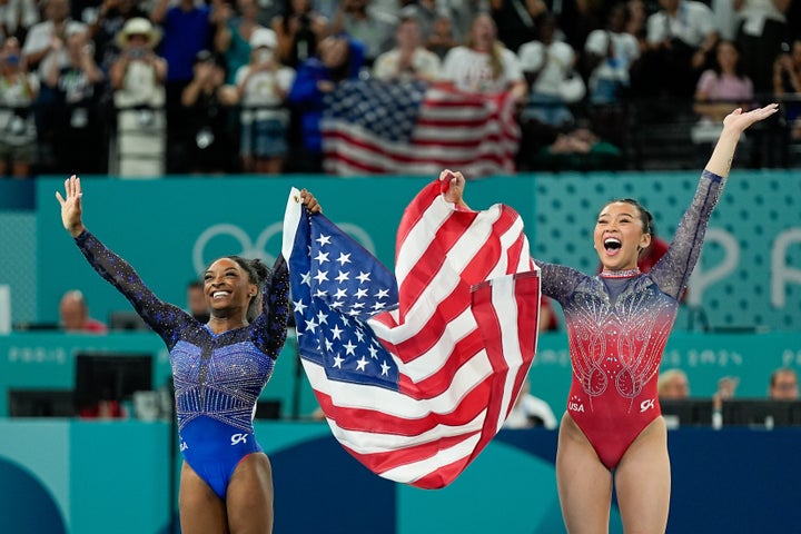 Lee and Simone Biles celebrate their victory in the individual all-around final.