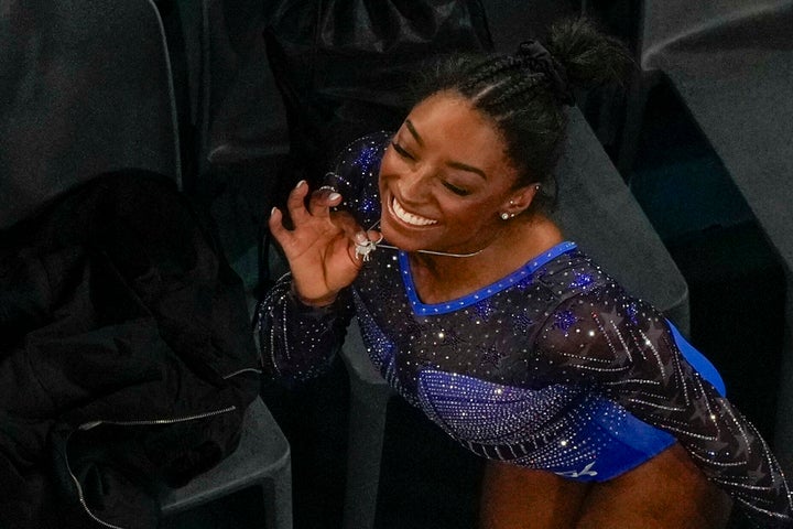 Biles showing off her necklace yet again.