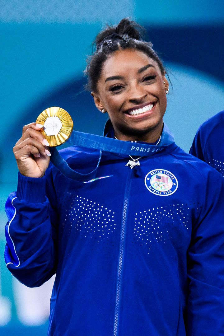 Biles with her sixth gold medal, and goat necklace, at the medal ceremony Thursday.