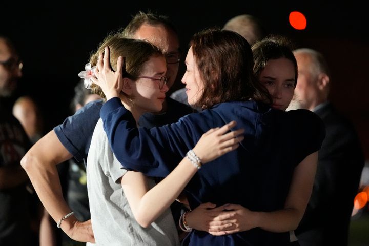 Alsu Kurmasheva, center, hugs her daughters after her release.