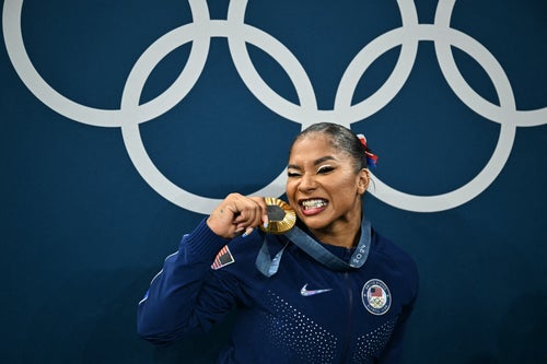 Jordan Chiles poses with the gold medal after the podium ceremony for the women's artistic gymnastics team final during the Olympics at the Bercy Arena in Paris, on July 30, 2024. (Photo by Lionel BONAVENTURE / AFP)