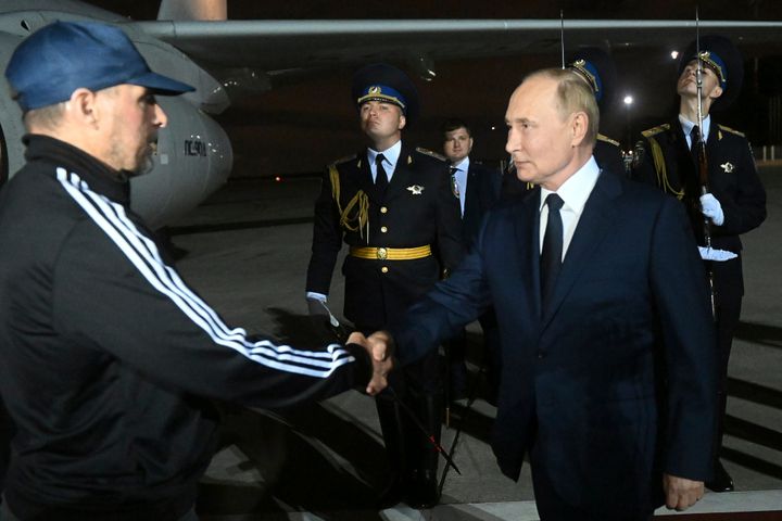 Russian President Vladimir Putin greets Vadim Krasikov upon arrival of freed Russian prisoners at Vnukovo government airport outside Moscow, Russia, Aug. 1, 2024.