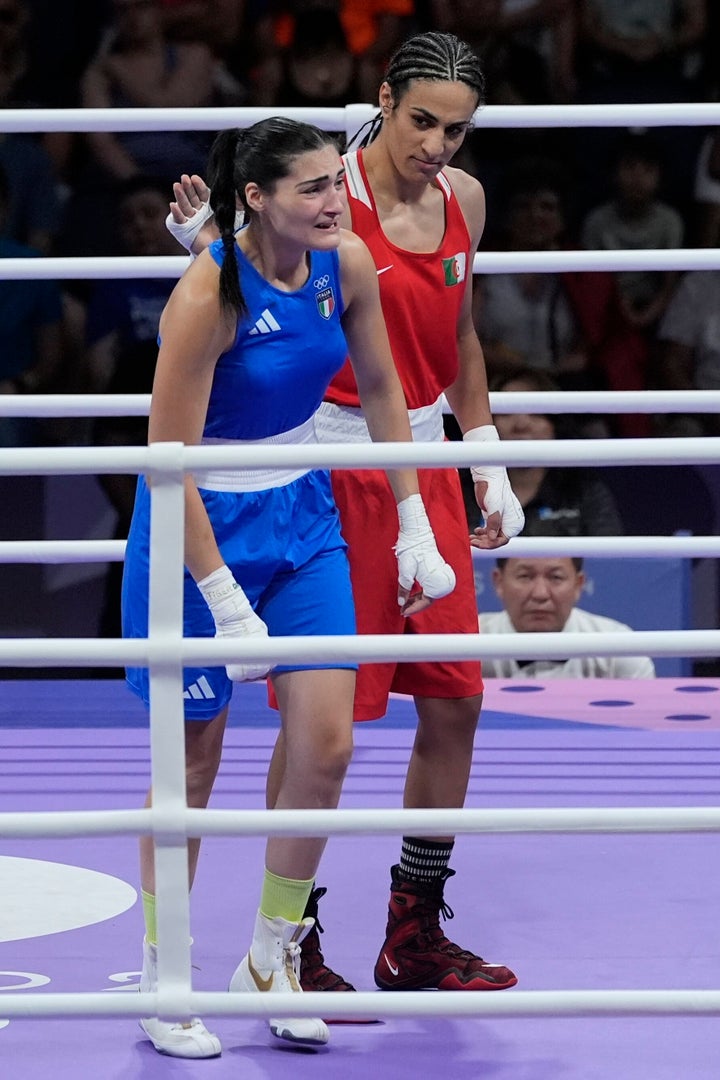 Algeria's Imane Khelif (in the red) appears to console Italy's Angela Carini at the end of their women's 66kg preliminary boxing match at the 2024 Summer Olympics. 