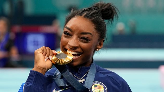 Simone Biles, of the United States, celebrates after winning the gold medal during the women's artistic gymnastics all-around finals in Bercy Arena at the 2024 Summer Olympics, Thursday, Aug. 1, 2024, in Paris, France. 