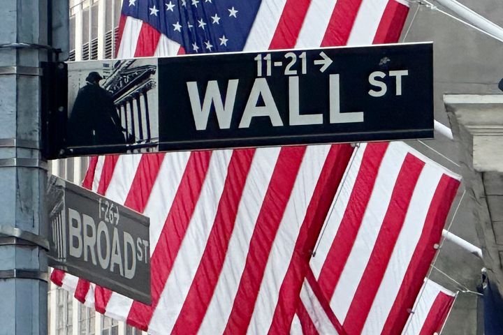 Amerikanische Flaggen wehen am Mittwoch, 22. Mai 2024, an der Fassade der New York Stock Exchange nahe der Kreuzung Broad Street und Wall Street in New York.  (AP Photo/Peter Morgan)