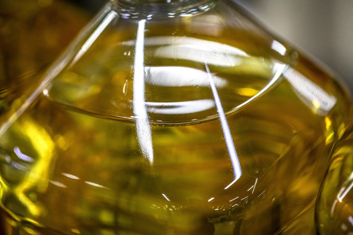 A close-up of a bottle of olive oil on a production line. Photographer: Angel Garcia/Bloomberg