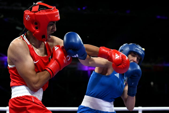 Algeria's Imane Khelif (in red) punches Italy's Angela Carini in the women's 66kg preliminaries round of 16 boxing match during the Paris Olympics.