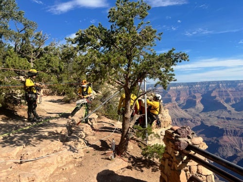 First responders work to recover the body of a man who died while attempting an illegal BASE jump.