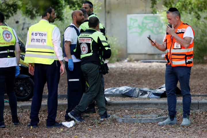 Israeli first responders work at the site of a stabbing attack, where police said a Palestinian killed a woman and wounded others in Holon, Israel on Sunday, Aug. 4, 2024.