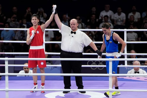 Taiwan's Lin Yu-ting celebrates after defeating Bulgaria's Svetlana Staneva in their women's 57 kg quarterfinal boxing match.
