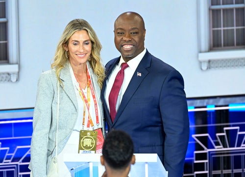 Sen. Tim Scott of South Carolina poses on stage with Mindy Noce after the Republican presidential debate in Miami on Nov. 8, 2023.