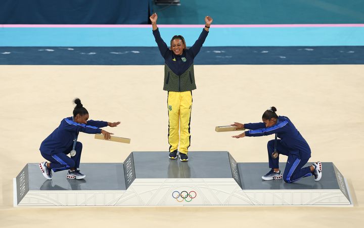 Gold medalist Rebeca Andrade (center) of Team Brazil, silver medalist Simone Biles (left) of Team United States and bronze medalist Jordan Chiles (right) of Team United States celebrate on the podium at the Artistic Gymnastics Women's Floor Exercise Medal Ceremony Aug. 5, 2024 in Paris.