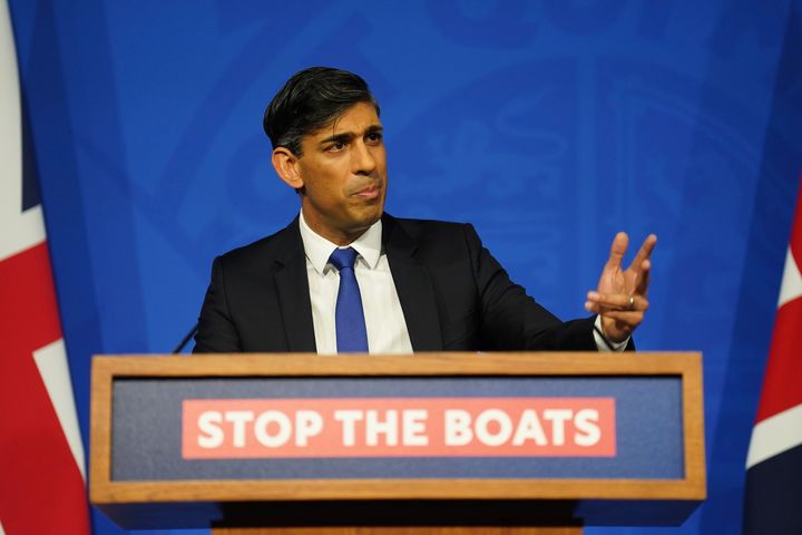 Former Tory PM Rishi Sunak standing on a podium with the slogan: "Stop the boats."