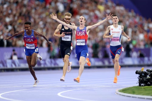 Cole Hocker raises his arms in triumph after his closing kick in the 1500 meters produced one of the Games' biggest upsets on the track.