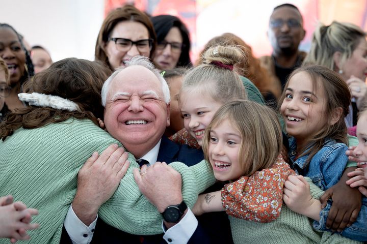 Gov. Tim Walz (D) gets a huge hug from students at Webster Elementary in Minneapolis, Minnesota, after he signed into law a bill that guarantees free school meals (breakfast and lunch) for every student in Minnesota's public and charter schools on March 17, 2023.