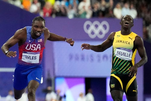 Noah Lyles, of the United States, left, wins the men's 100-meter final at the 2024 Summer Olympics, Sunday, Aug. 4, 2024, in Saint-Denis, France. 