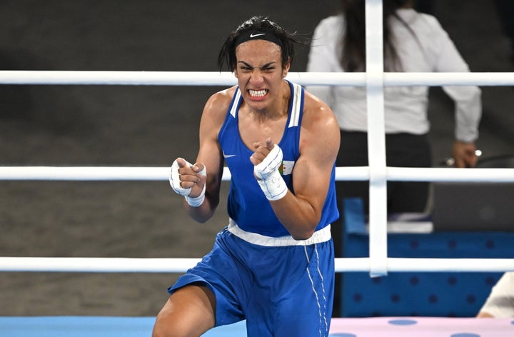 Imane Khelif of Algeria celebrates after defeating Janjaem Suwannapheng of Thailand.