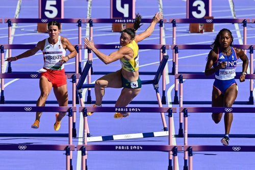 Jenneke falls as Hungary's Gréta Kerekes, left, and France's Cyréna Samba-Mayela, right, run in the women's 100-meter hurdles heat at the Paris Olympics.