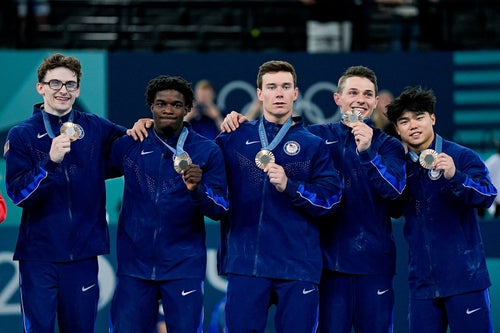 Stephen Nedoroscik (left) with his teammates, Frederick Richard, Brody Malone, Paul Juda and Asher Hong, as they pose for a photo with their bronze medals during the men's artistic gymnastics team final on July 29 in Paris.
