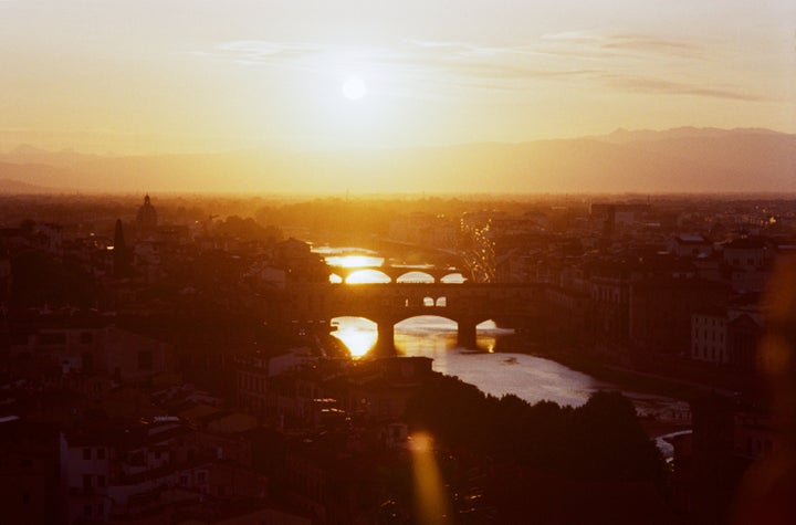 Italy, Tuscany, Florence, Ponte Vecchio and city skyline along River Arno