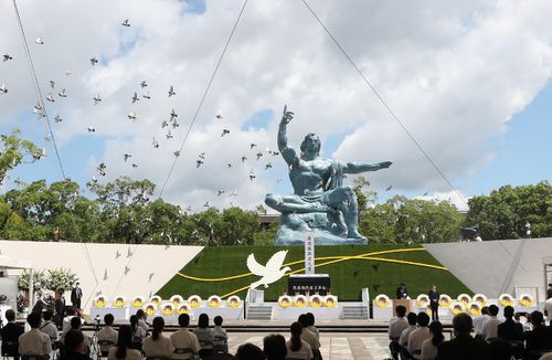 Doves fly during a memorial service for victims of the U.S. atomic bombing at the Nagasaki Peace Park in Nagasaki on Aug. 9, 2021.