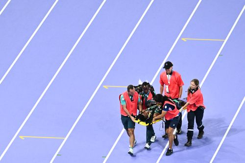 Medical staff carried Lamecha Girma off the track.