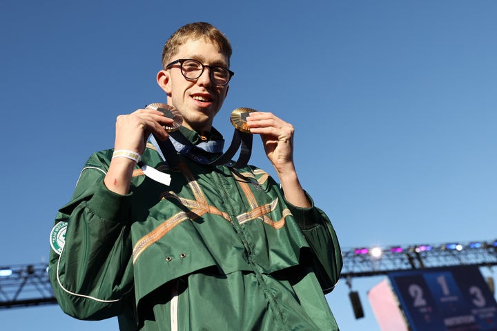 Daniel Wiffen of Team Ireland poses with his medals.